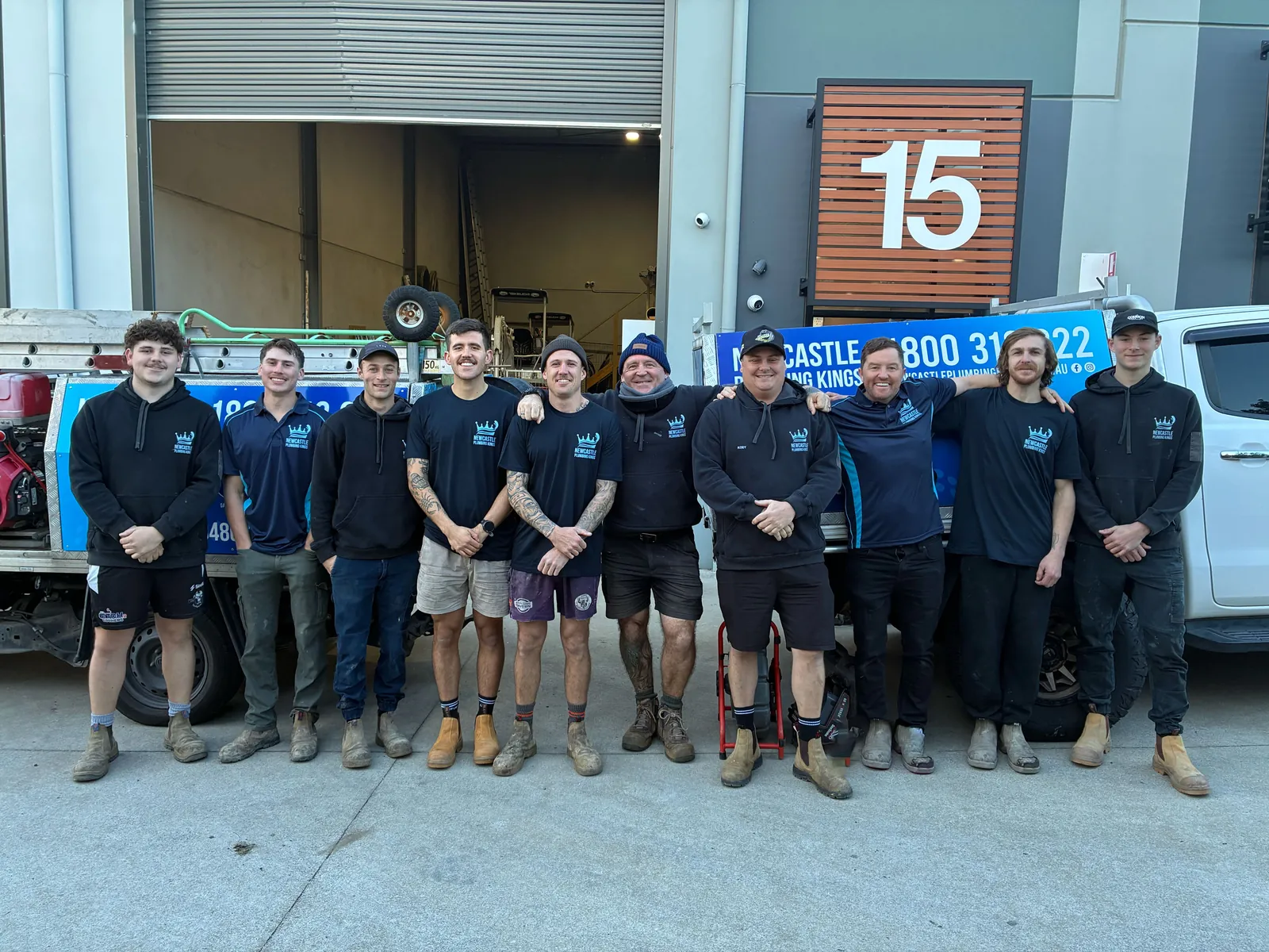 The plumbing team standing beside the work ute